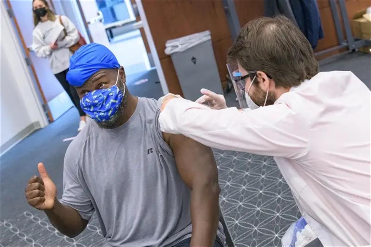 Carlton Cooper, an assistant professor in the University of Delaware Department of Biological Sciences, was among the staff receiving a COVID vaccination through the UD clinic held at the Tower at STAR.